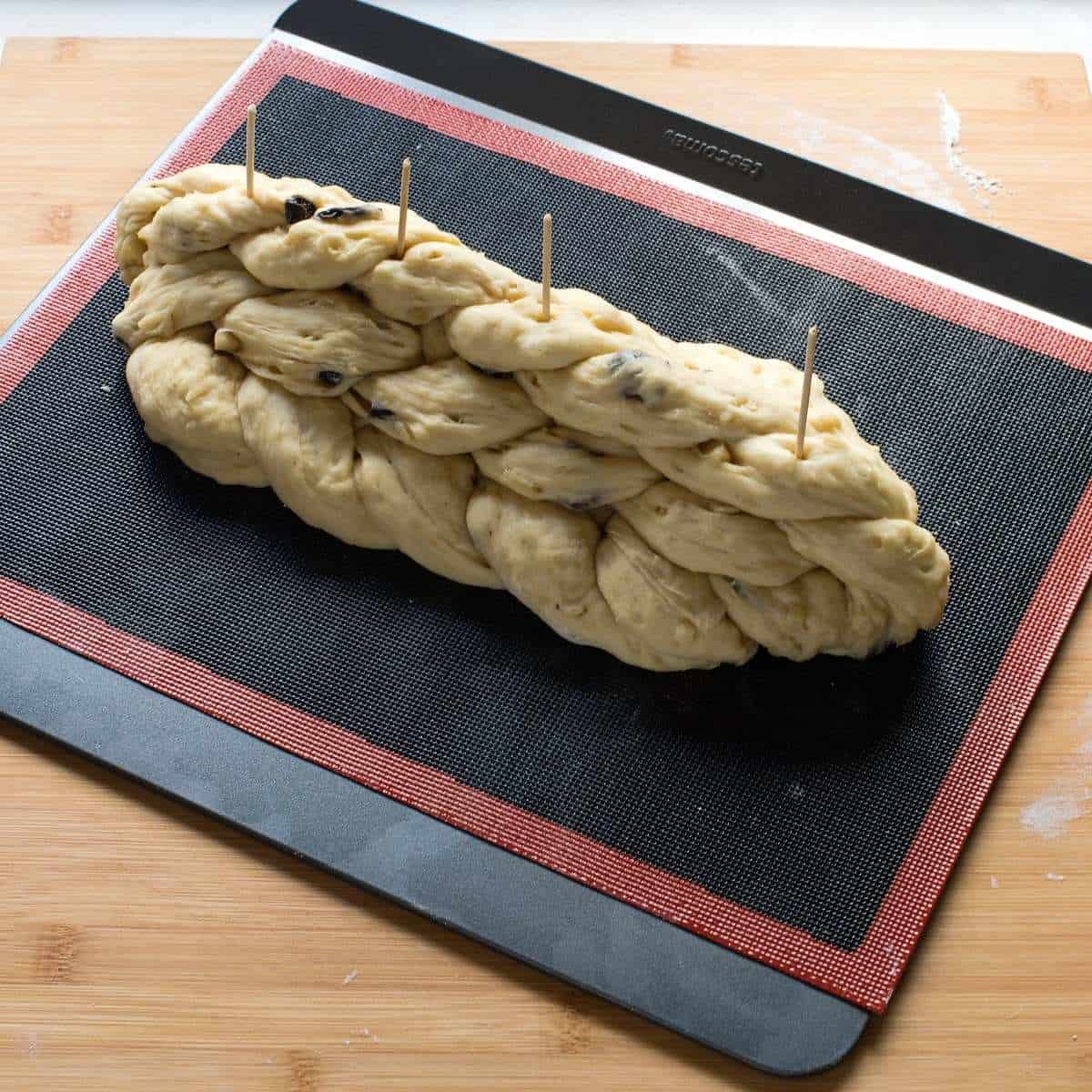 Czech vánočka, braided, laid on a baking sheet.