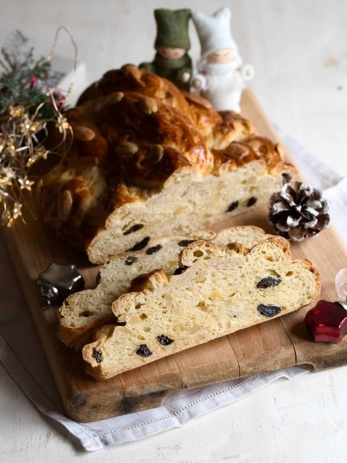 Czech vánočka, sliced, served on a wooden board.