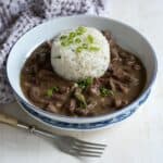 Pork kidney stew served with rice in a bowl.
