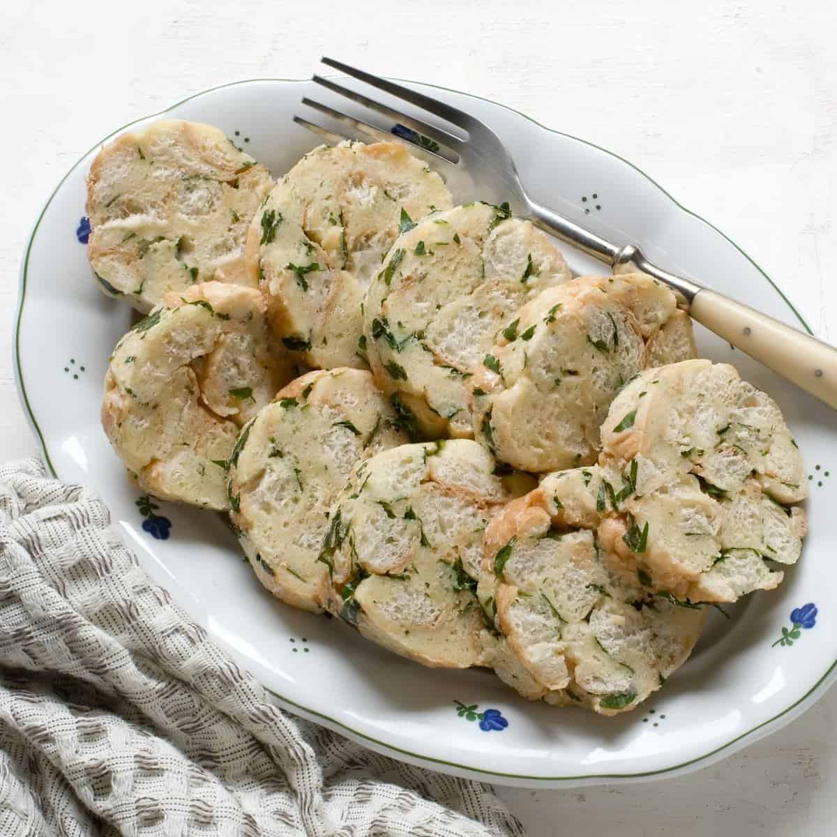 Sliced Carlsbad dumplings (karlovarské knedlíky) on a plate.