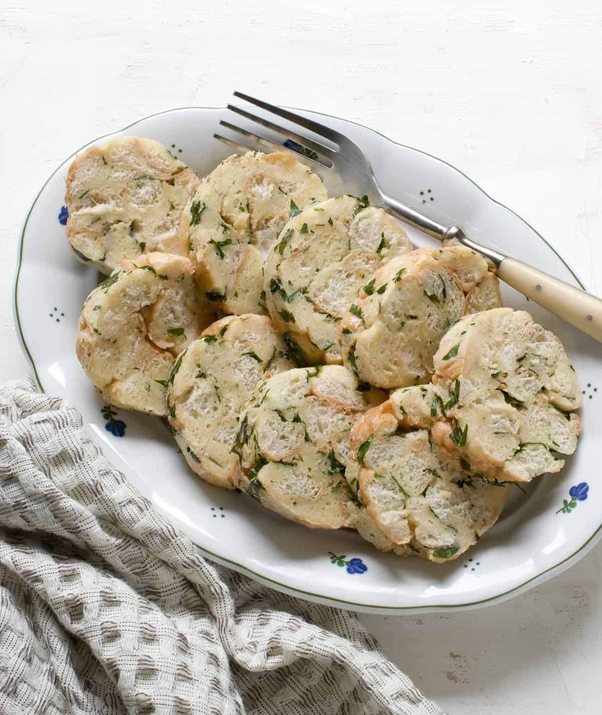 Sliced Carlsbad dumplings (karlovarské knedlíky) on a plate.