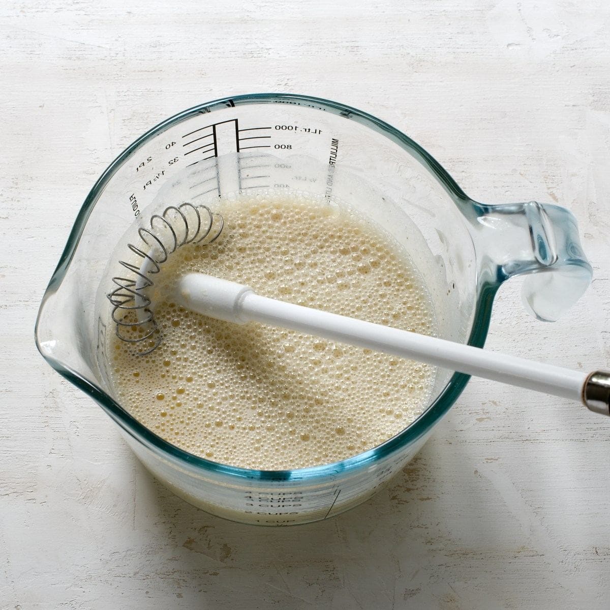 Whisked milk with eggs to create a mixture for Czech Carlsbad dumplings.