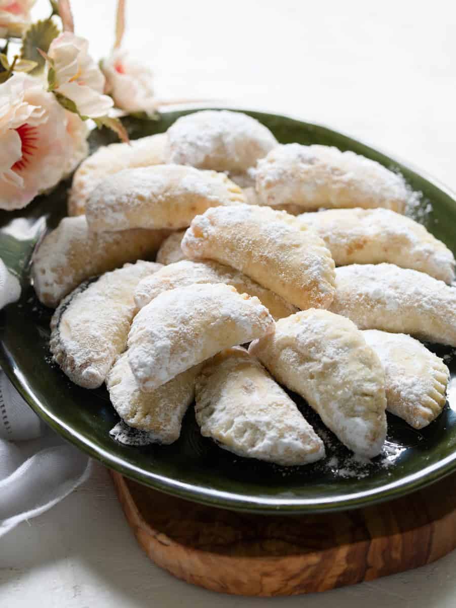 A plate of baked Czech cheese dough crescents with blum butter (šátečky plněné povidly).