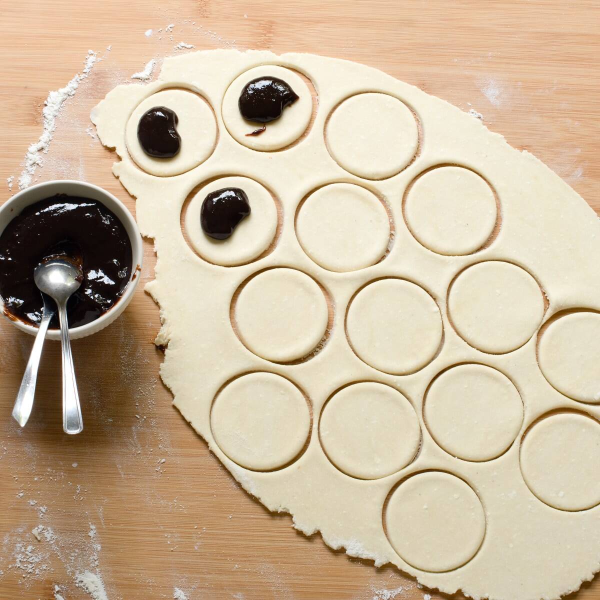 Filling cut-outs with plum butter.