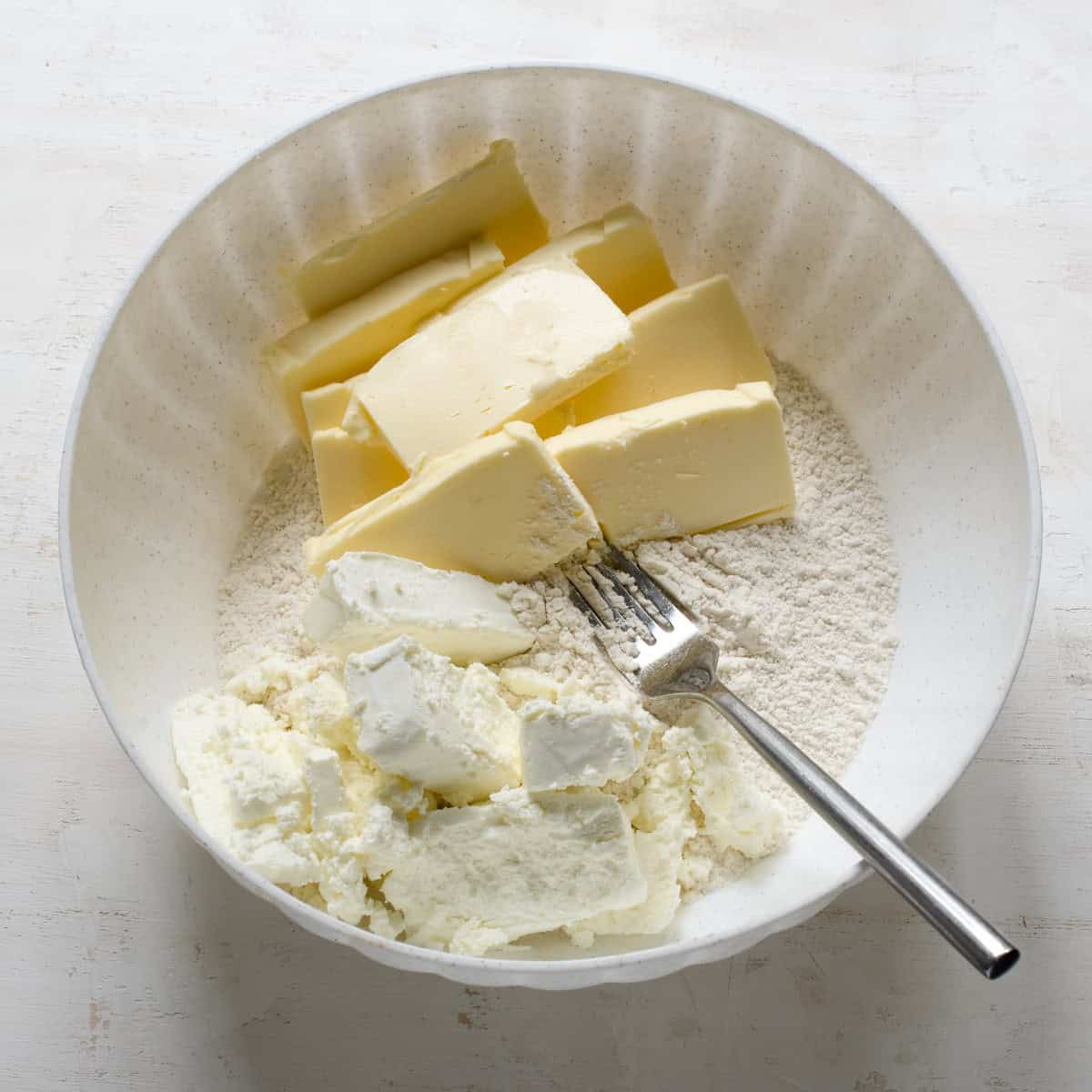 Making farmers cheese dough with butter and flour.