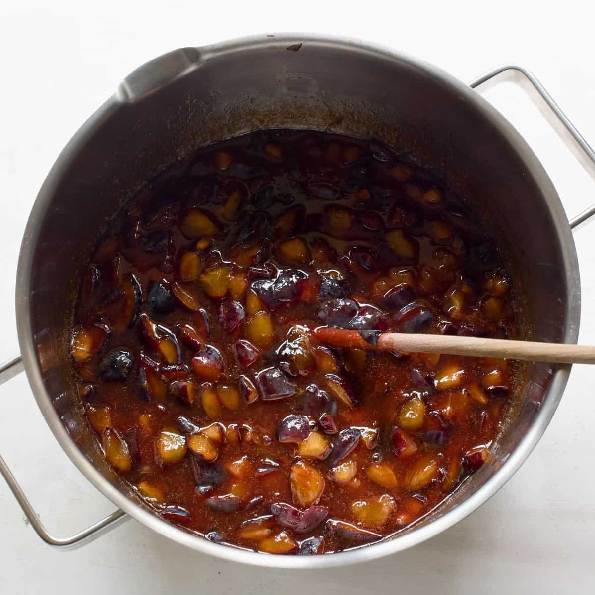 Pieces of plums in a large pot.
