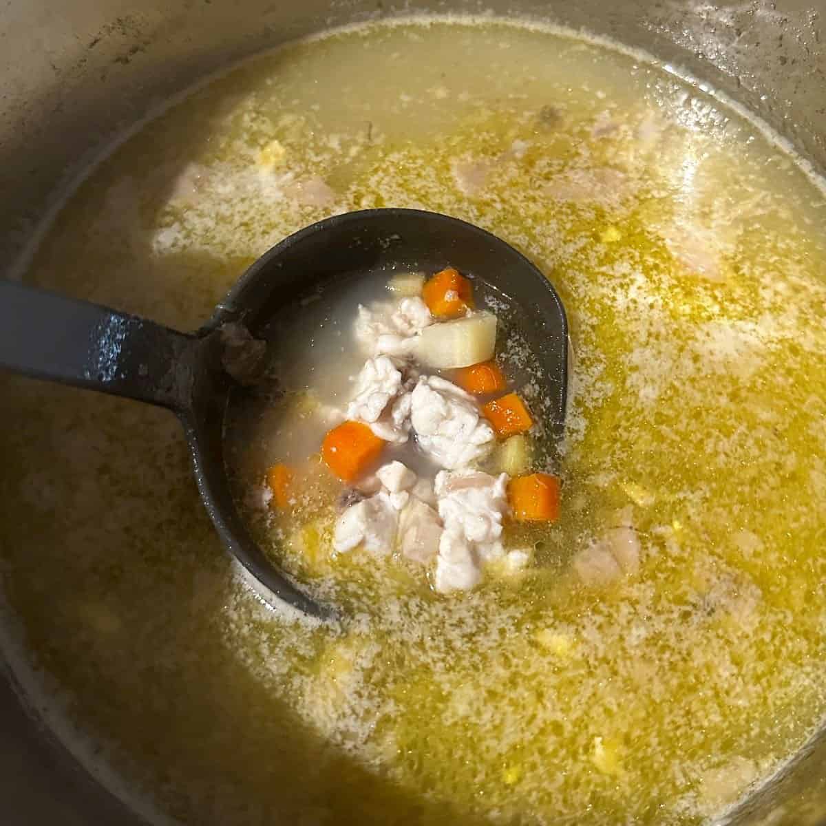 Cooked fish soup scooped.