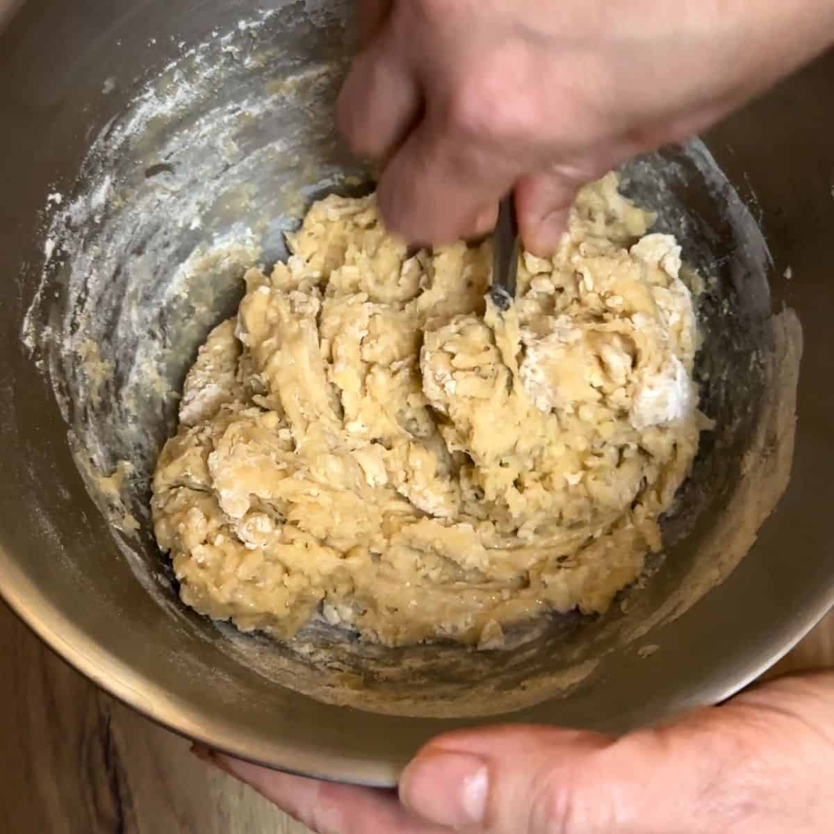 Mixing the yeast dough before kneading to get a rough mass.
