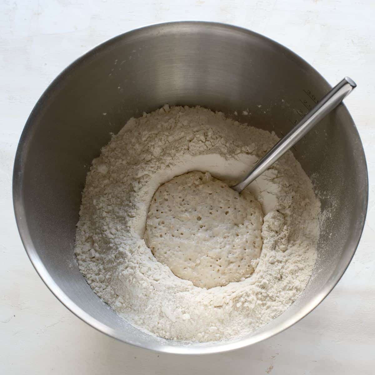 Activated yeast in a bowl with flour.
