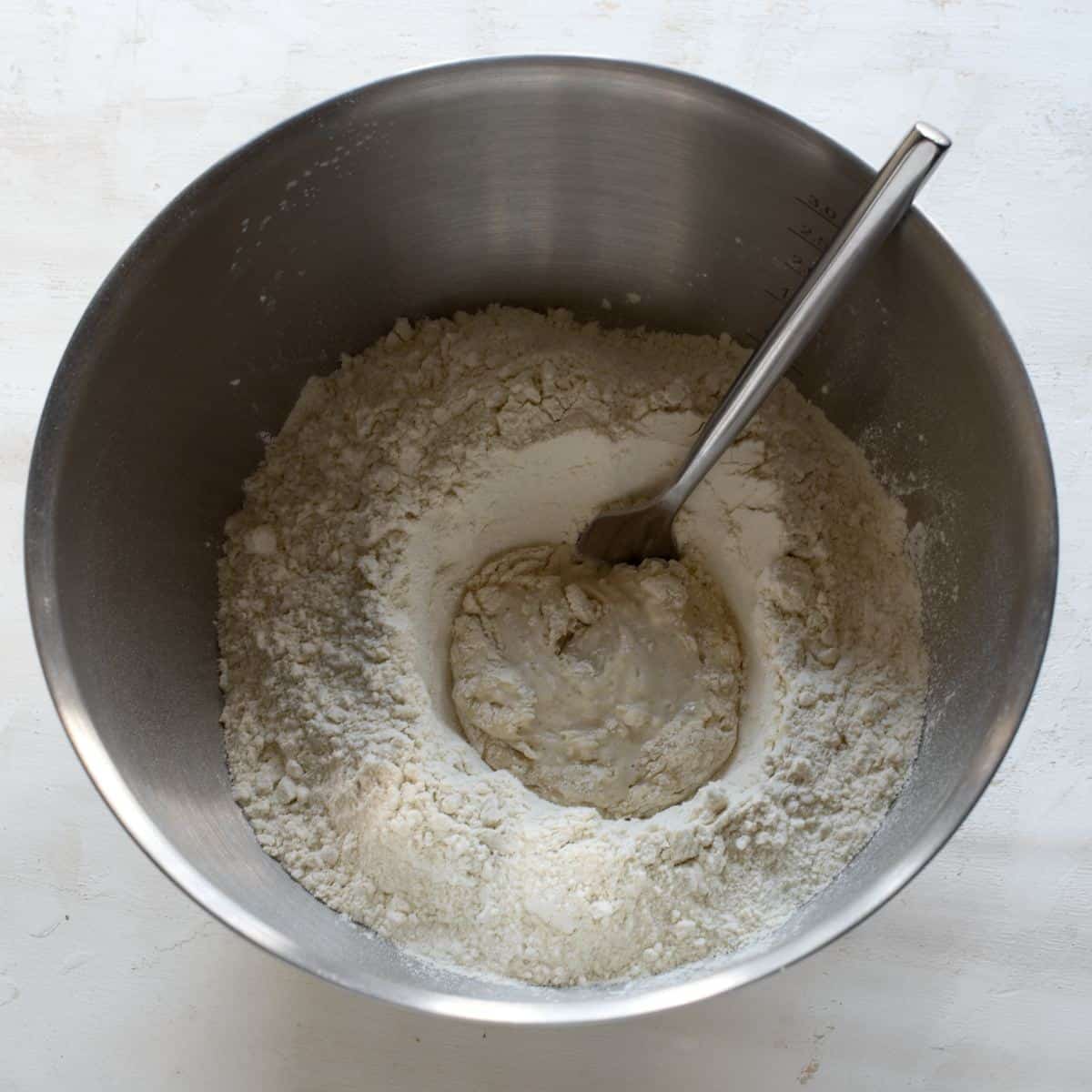 Activating yeast in a bowl with flour.