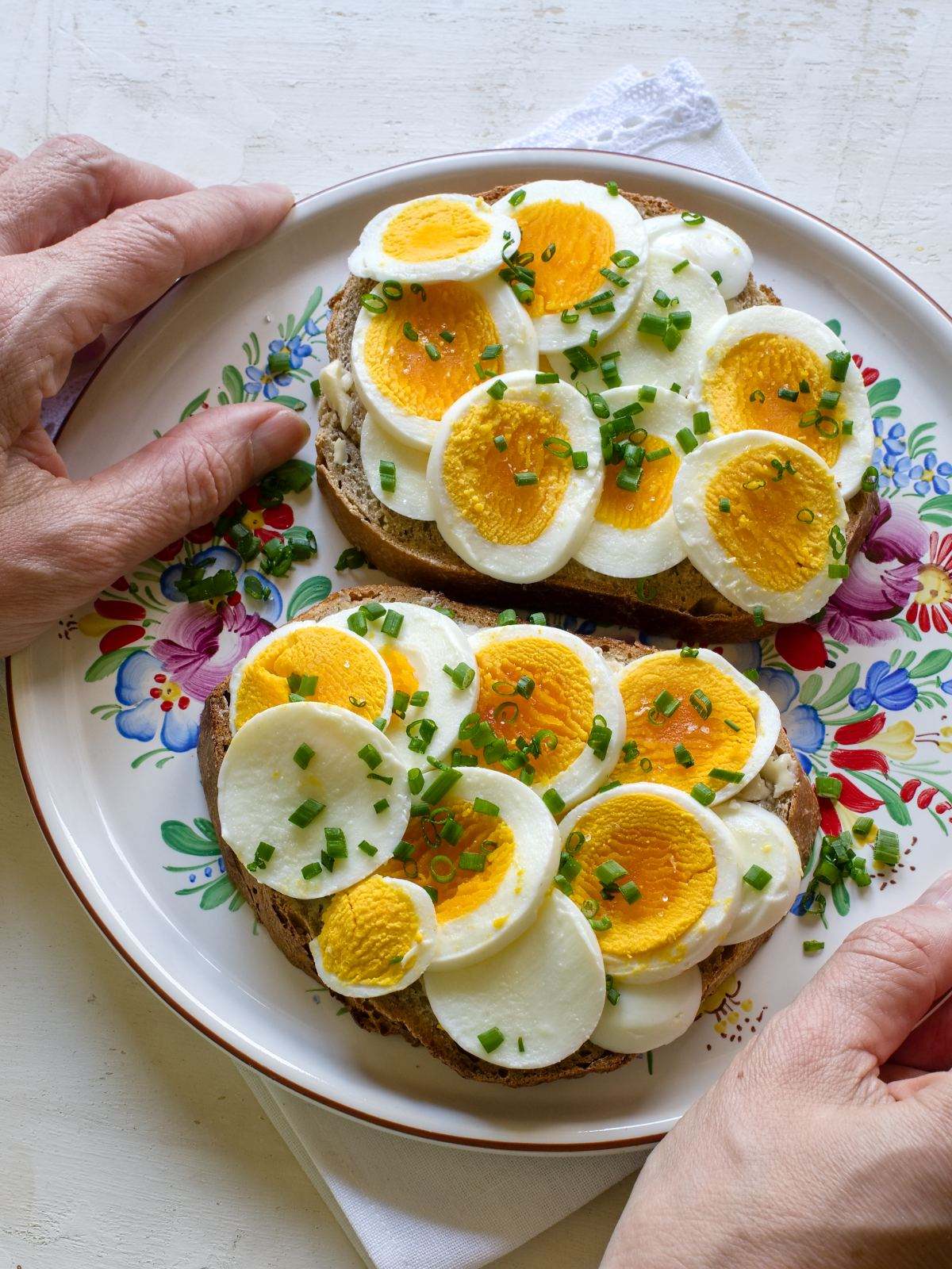 Czech bread slices smeared with butter, topped with sliced hard-boiled eggs.