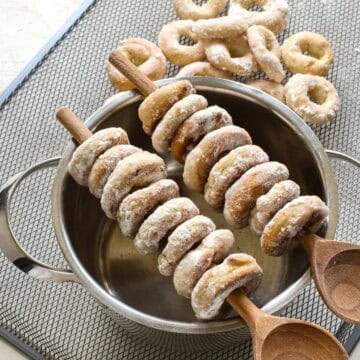 Czech Lomnicke krouzky threaded on wooden spoons.