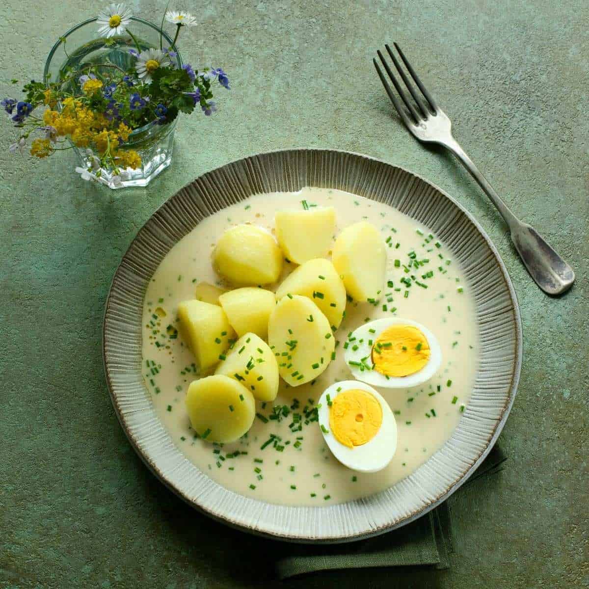 Chive sauce served with boiled potatoes.