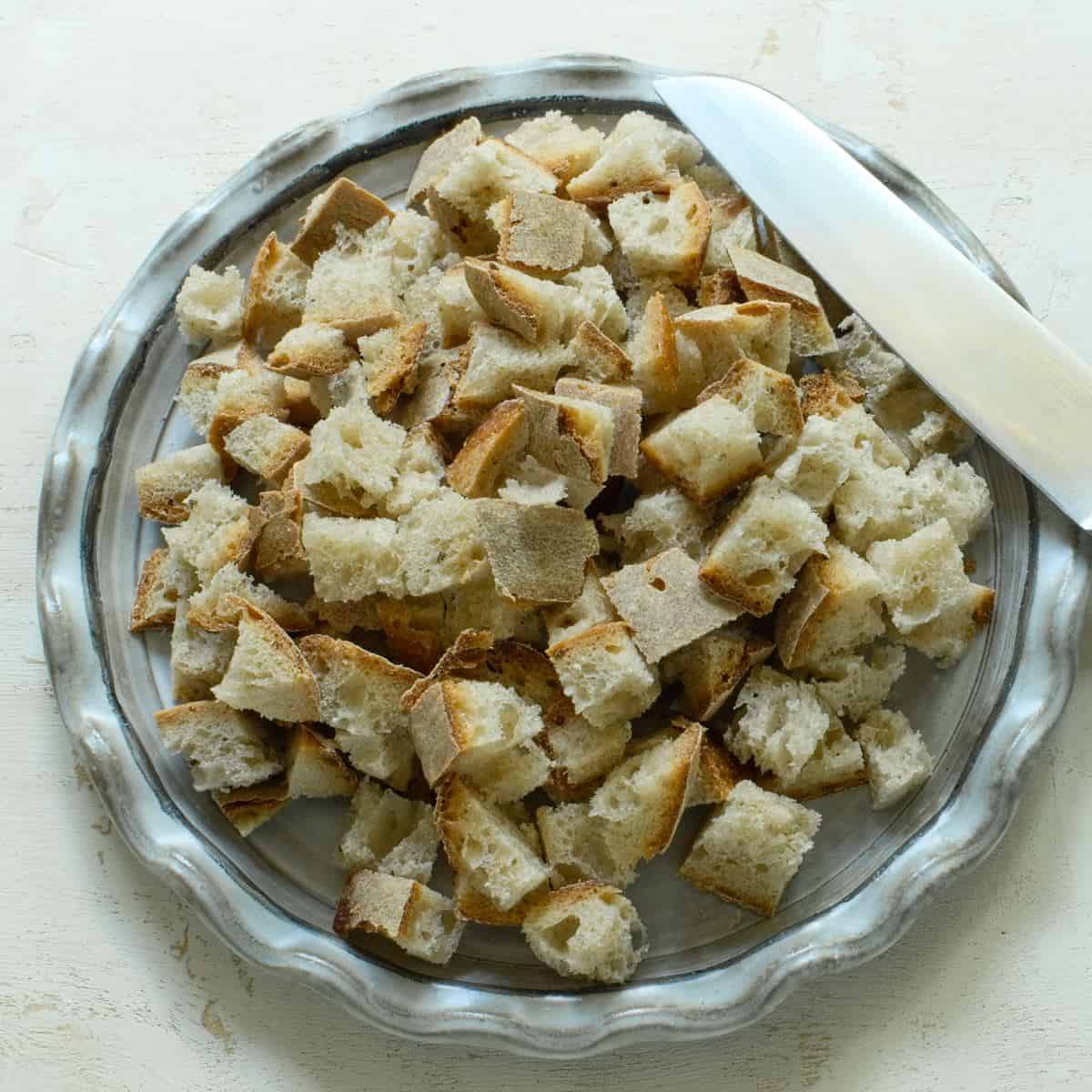 Bubed bread on a plate.