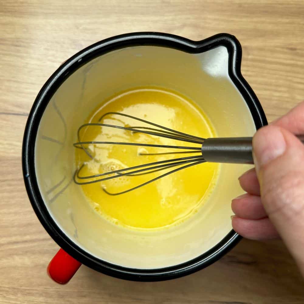 Mixture of melted butter, milk and egg in a smal saucepan.