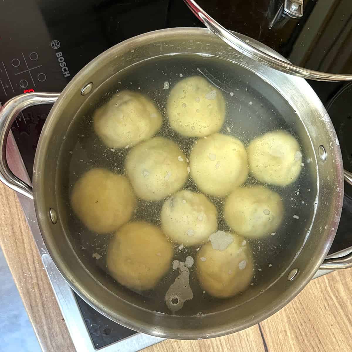 Cooking potato dumplings in a pot of water.