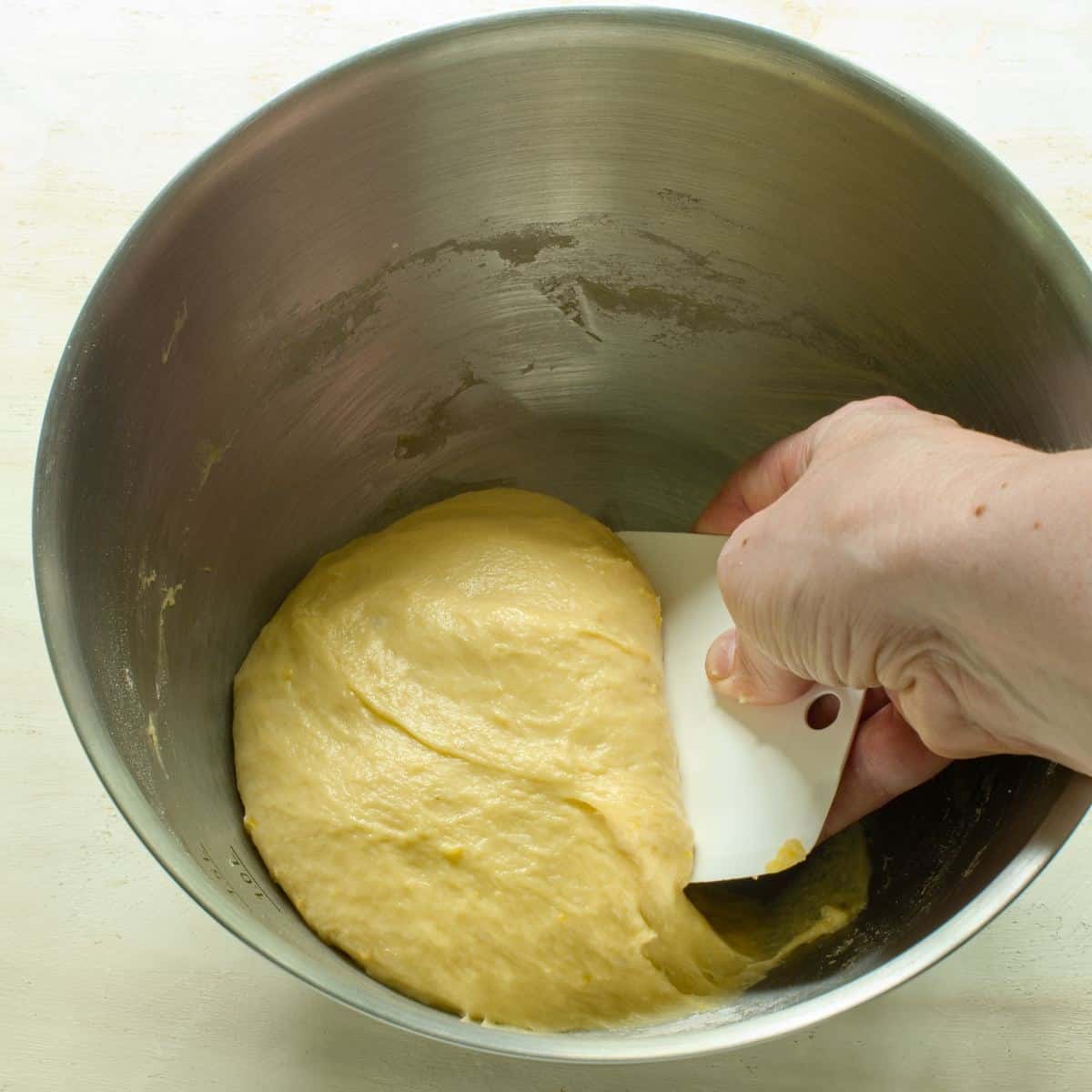 Handling beaten dough with a dough scraper.