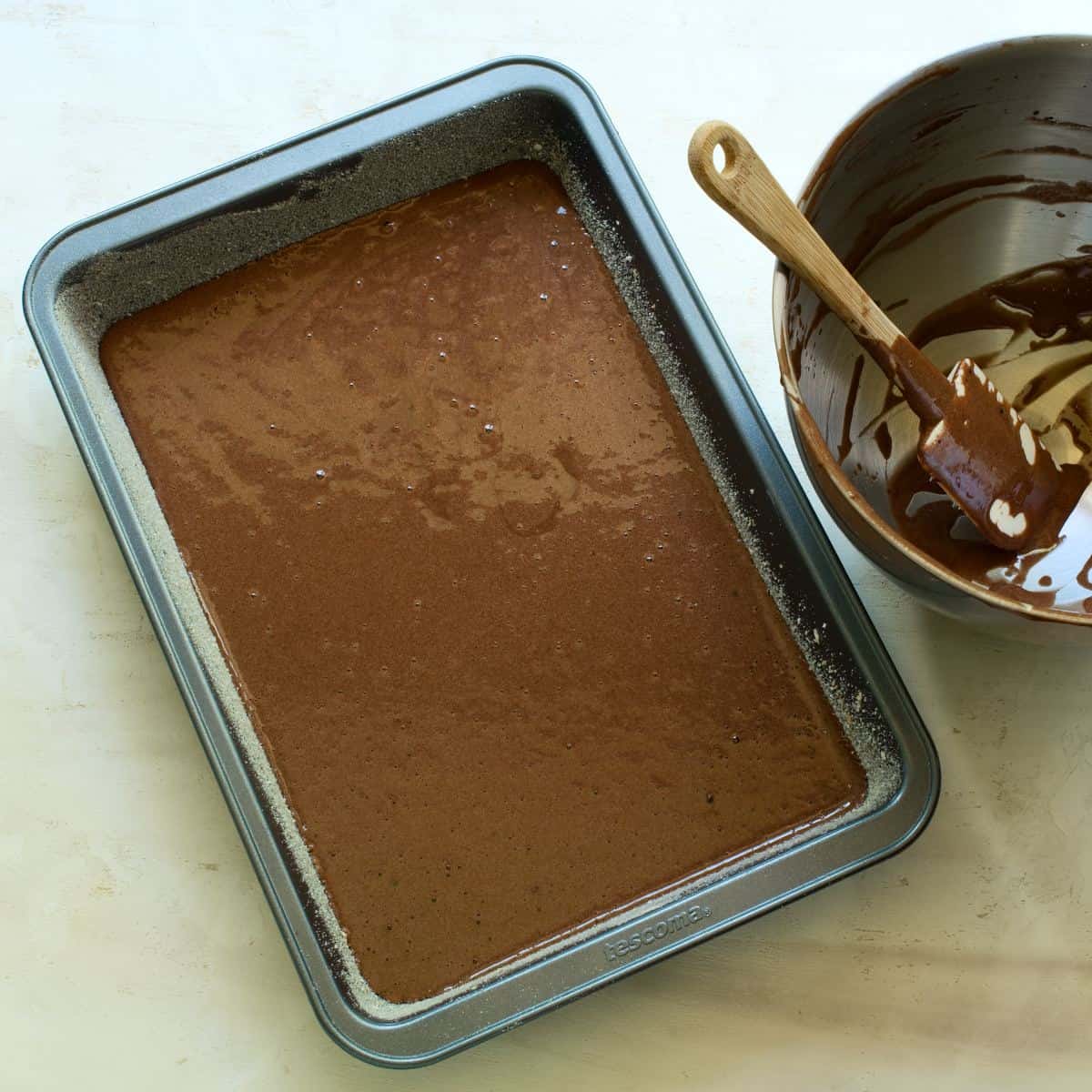 Cocoa batter spread in a baking pan.