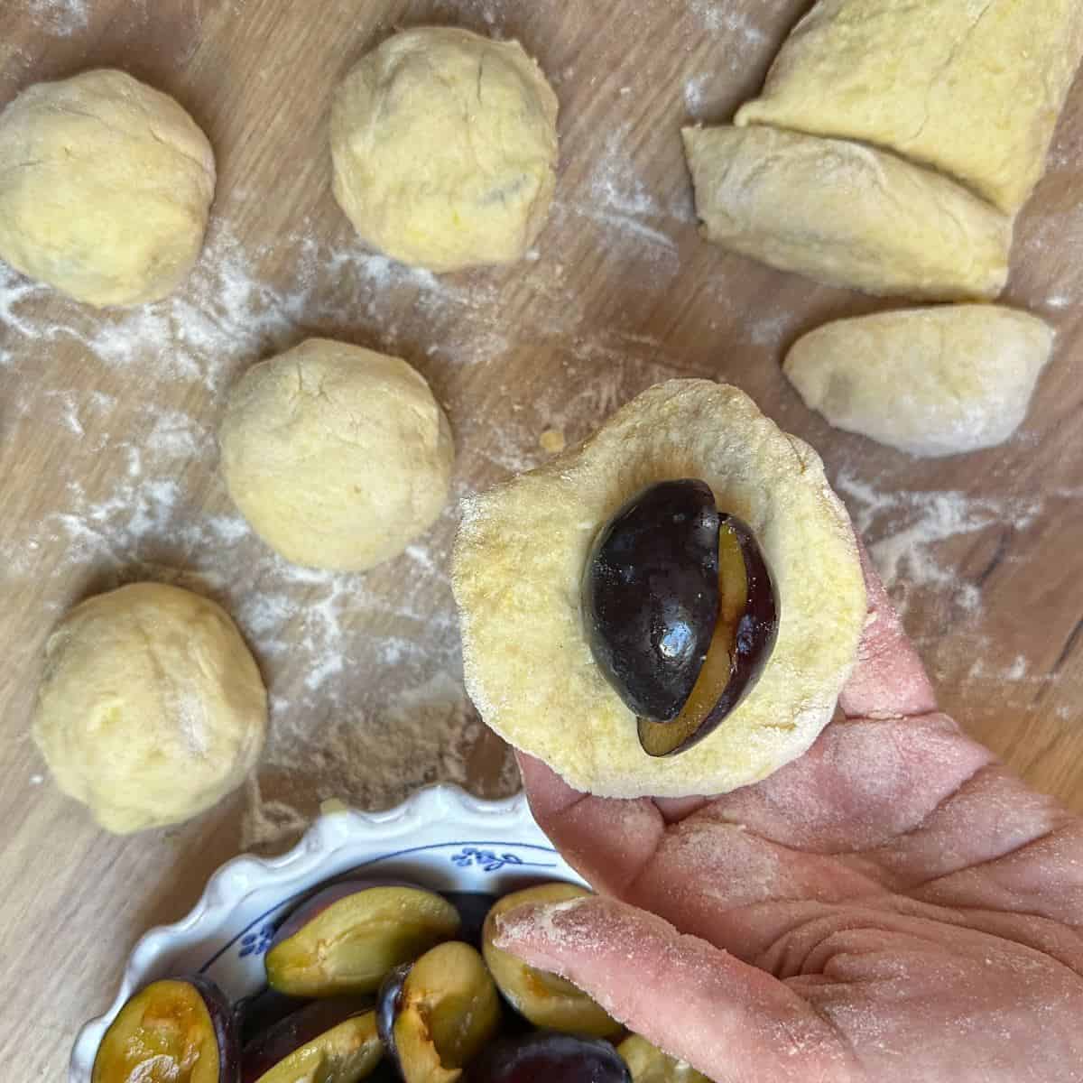 Shaping plum dumplings with poatato dough.